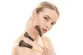 The beautiful girl with cosmetic brushes on the white background Photo