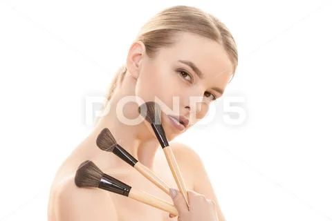 The beautiful girl with cosmetic brushes on the white background Stock Photos