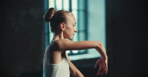 Beautiful girl dancer performs elements of classical ballet in the loft design Stock Footage