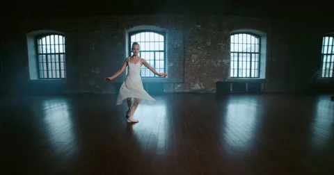 Beautiful girl dancer performs elements of classical ballet in the loft design Stock Footage