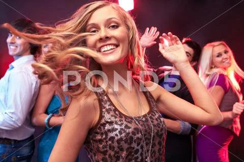 A beautiful girl dancing against her friends Stock Photos