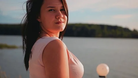 Beautiful girl on the dock posing for the camera. Very cool slow motion footage Stock Footage 113996893