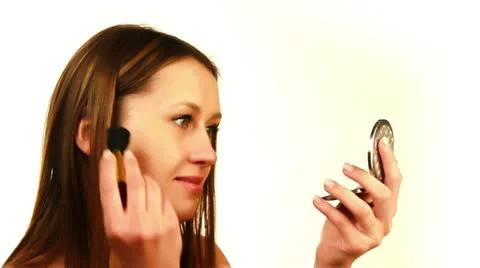Beautiful girl does make-up on a white background Stock Footage 10873155