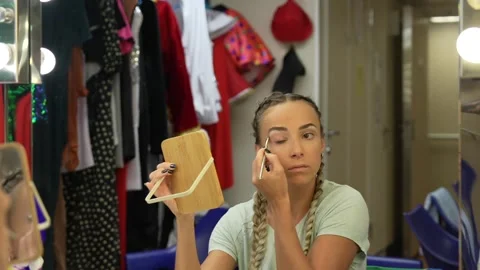 Beautiful girl is doing make up in dressing room. Stock Footage 256896643