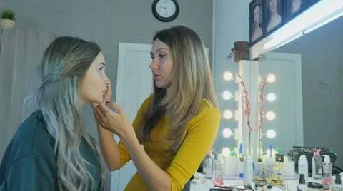 Beautiful girl doing makeup Stock Footage