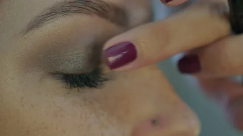 Beautiful girl doing makeup Stock Footage