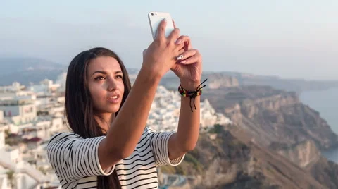 Beautiful girl doing a selfie and sending it in a text message Stock Footage