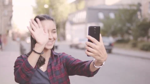 Beautiful girl doing selfie while walking around the city. Stock Footage 93801716