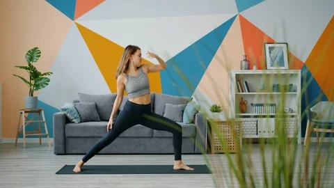 Beautiful girl doing yoga exercises at Stock Video Pond5