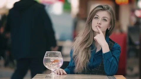 The beautiful girl dreaming at the table Stock Footage