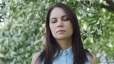 Beautiful girl in a dress with a apple at the apple tree Stock Footage