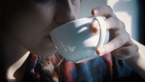 Beautiful girl drinking a cup of coffee in a beach bar Stock Footage