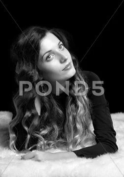 Beautiful girl on furs Stock Photos