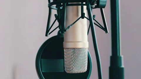 Beautiful girl gives an interview in studio microphone Stock Footage