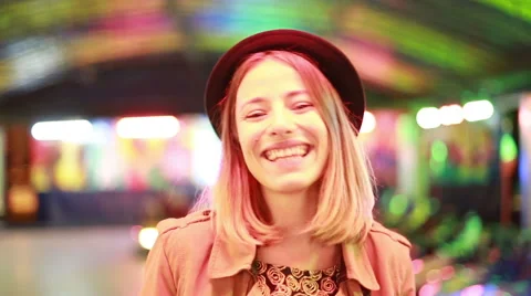 Beautiful girl in hat looking at camera, smiling and winking Stock Footage 59556336