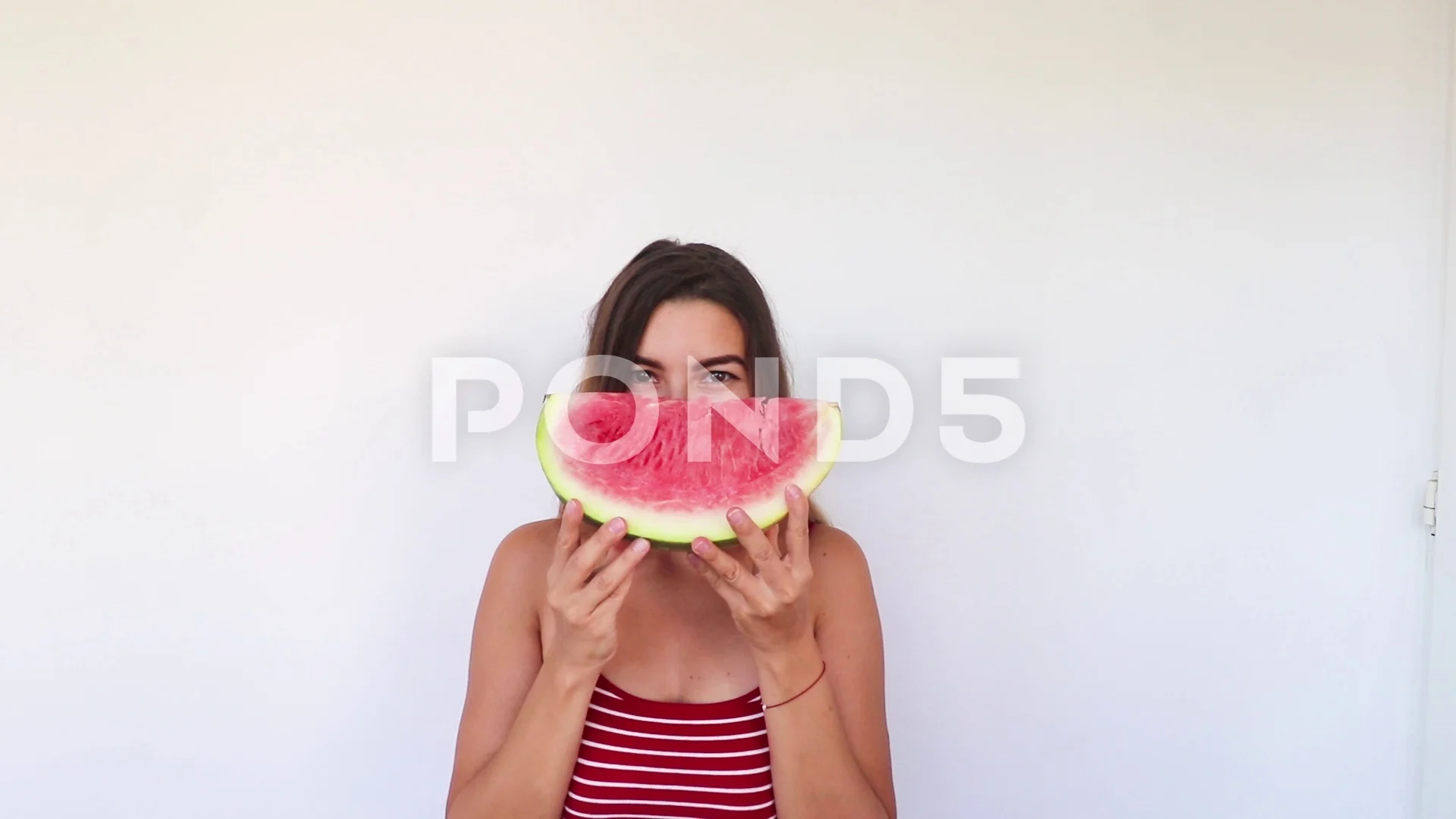 Beautiful girl Hiding Behind Watermelon Then Laughing in Slow Motion