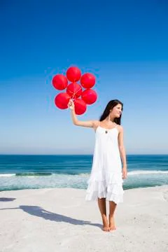 Beautiful girl holding red ballons Stock Photos