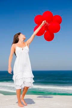 Beautiful girl holding red ballons Stock Photos
