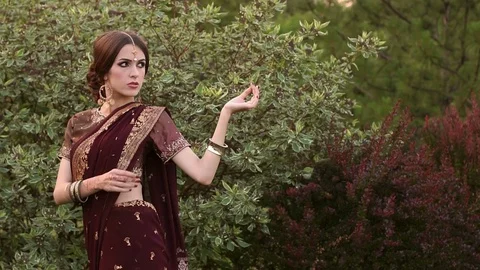 Beautiful girl in the Indian suit Sari in Park. Stock Footage