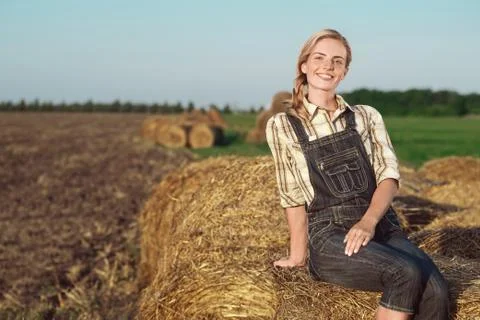 Beautiful girl in jeans on the field Stock Photos