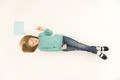 The beautiful girl lay on floor near the dialog sign. View from above Photo