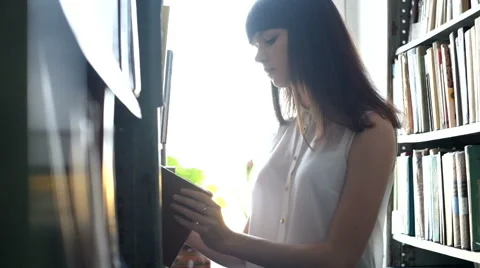 Beautiful girl in the library Stock Footage 61751663