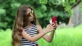 Beautiful girl with long hair makes selfie on his smartphone HD Footage