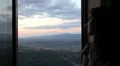 beautiful girl looks a wonderful landscape from her window HD Footage