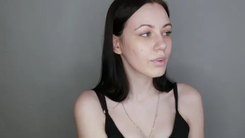 Beautiful girl model posing in front of the camera. Young woman without makeup Stock Footage 156239207