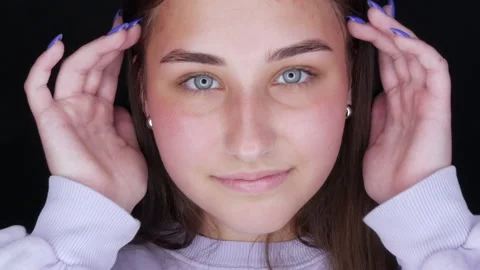 Beautiful girl model posing in front of the camera. Young woman without makeup Stock Footage 157359064