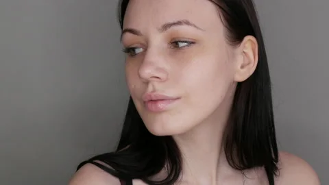 Beautiful girl model posing in front of the camera. Young woman without makeup Stock Footage 203746128