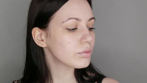 Beautiful girl model posing in front of the camera. Young woman without makeup Stock Footage 203763047
