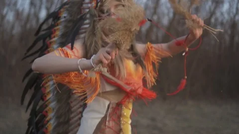 Beautiful girl in native american indian headdress and costume  Stock Footage