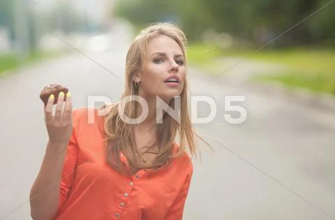 Beautiful girl in orange suit with cake Stock Photos