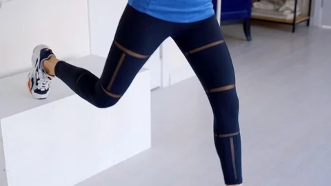 Beautiful girl performs a split squat on one leg. She plays sports at home. Video stock 126342603