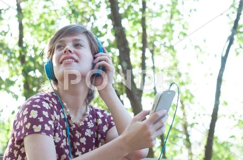Beautiful Girl On The Phone Listen Music In A Sunny Day