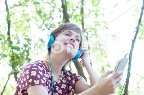 Beautiful Girl On The Phone Listen Music In A Sunny Day
