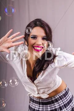 Beautiful girl playing with soap bubbles Stock Photos