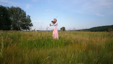 Beautiful girl playing the violin in the field Stock Footage