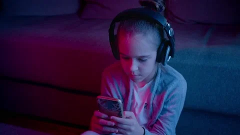A beautiful girl plays computer games in a neon light. Esports in smartphone Stock Footage 130364853