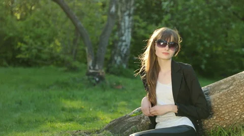 Beautiful girl posing at sunset at the tree in the forest. Stock Footage 64117747