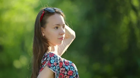 Beautiful girl posing at sunset at the tree in the forest. Stock Footage 64127772