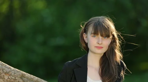 Beautiful girl posing at sunset at the tree in the forest. Stock Footage 64127958