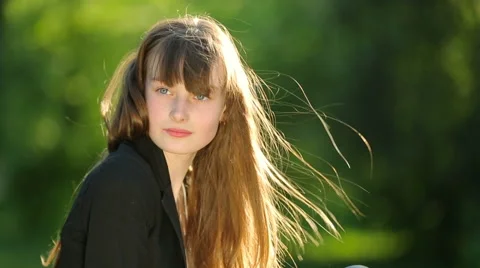 Beautiful girl posing at sunset at the tree in the forest. Stock Footage 64128258