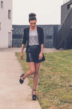 Beautiful girl posing in an urban context Stock Photos