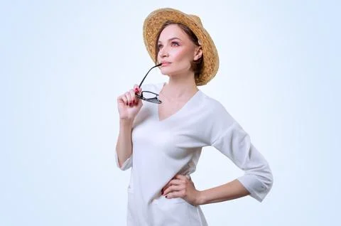 Beautiful girl posing on a white background in a yellow hat. Tourism concept. Stock Photos