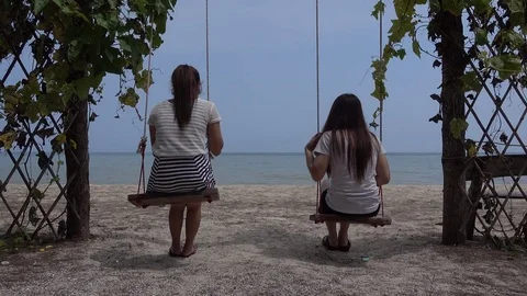 Beautiful girl relax on a swing at the beach, 4K Stock Footage