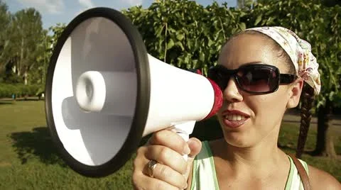 Beautiful girl screaming into a megaphone Stock Footage