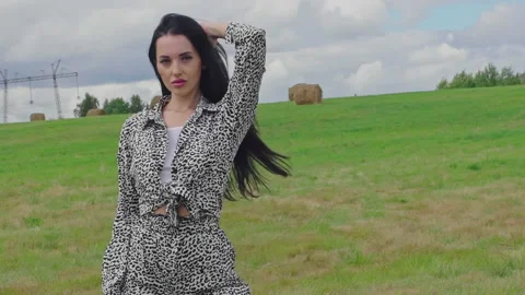 Beautiful girl sensually posing on camera. Woman touching her long dark Hair 4K Stock Footage 158675041