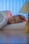 The beautiful girl sleeping on the bed. Evening night time Photo